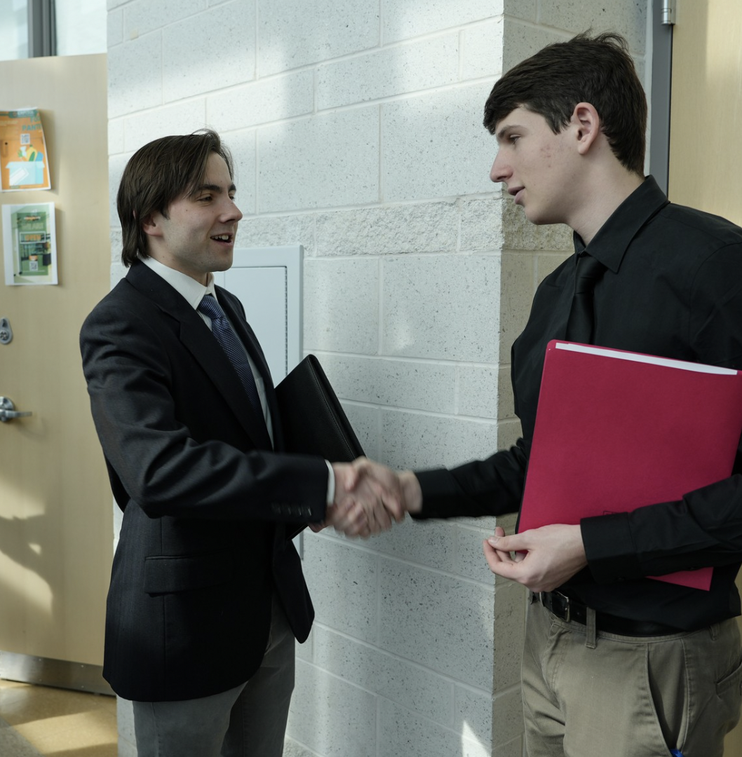 students at career conference shaking hands