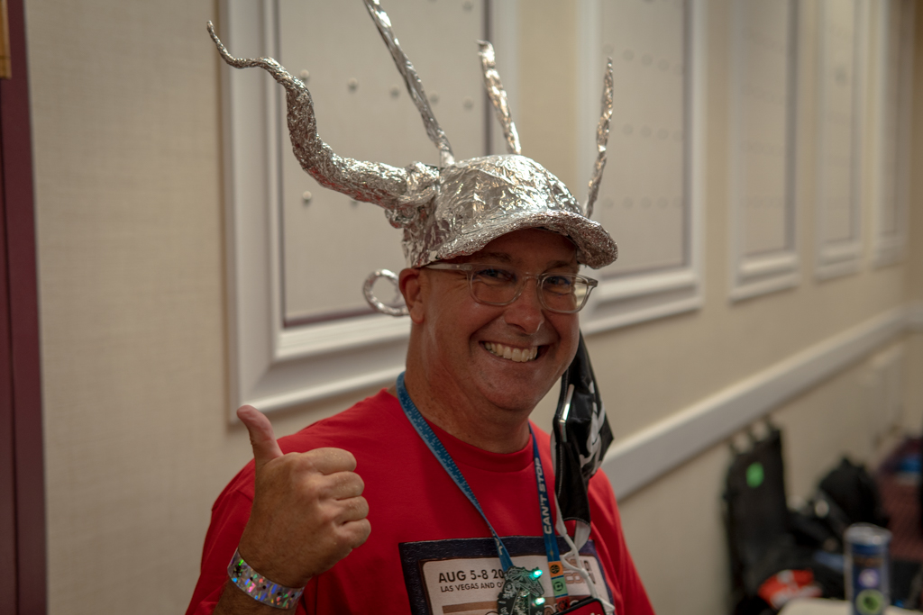 def con person wearing tin foil hat